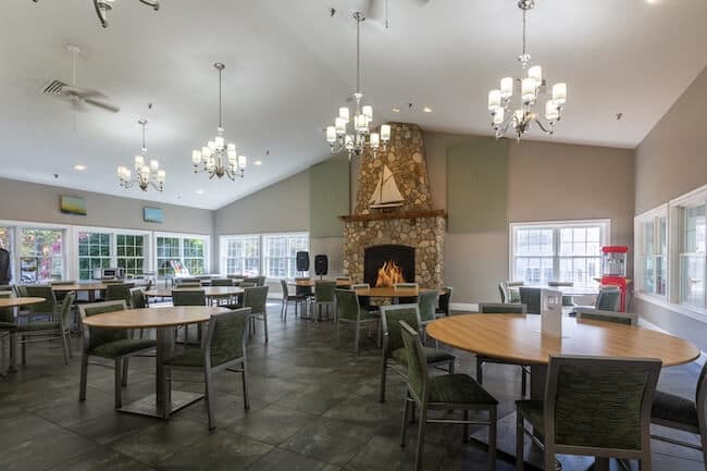 Round dining tables in large room with chandeliers